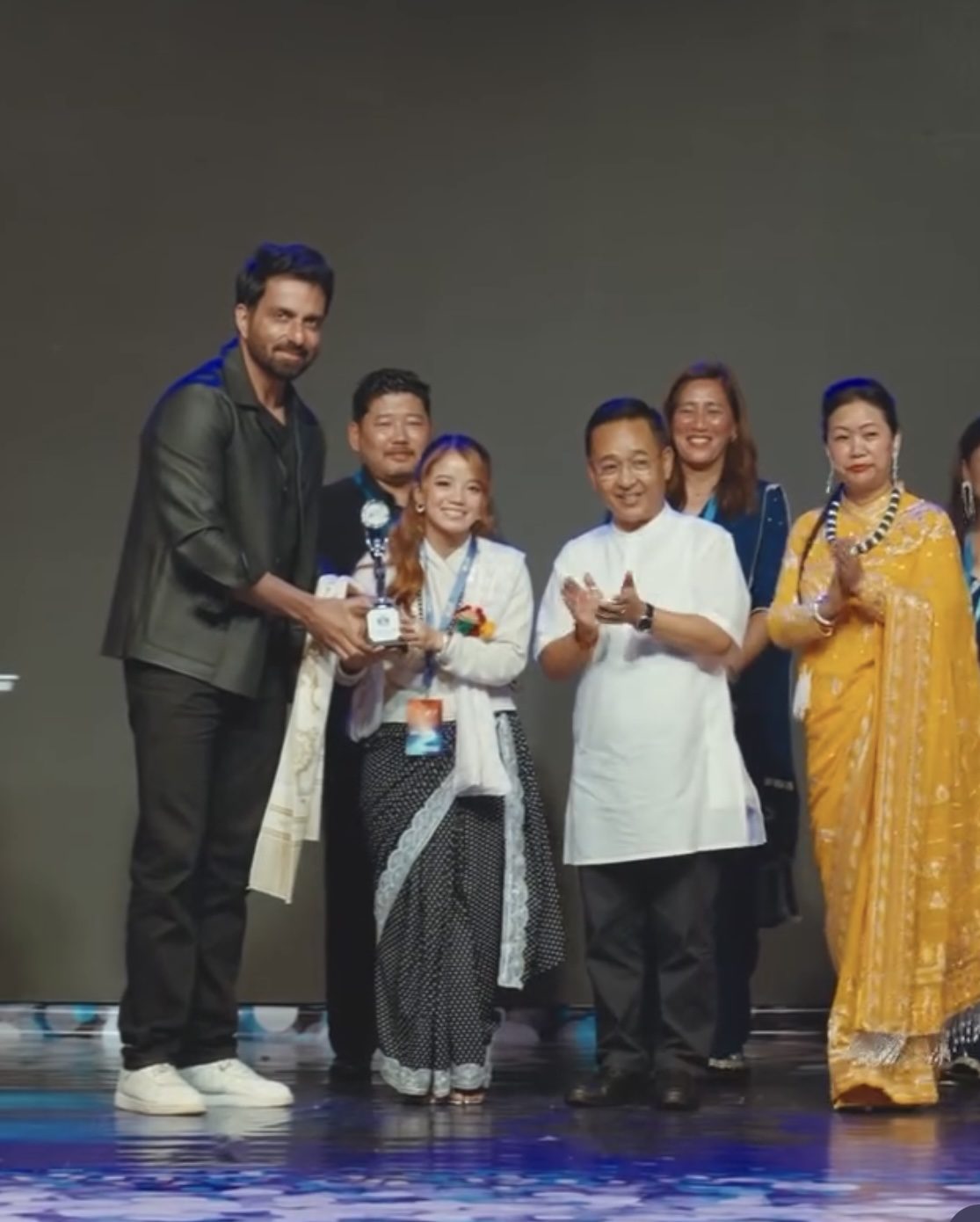 Amrita Rai receiving a trophy on stage at the Sikkim Kalakar Bharosa Sammelan, felicitated alongside state dignitaries